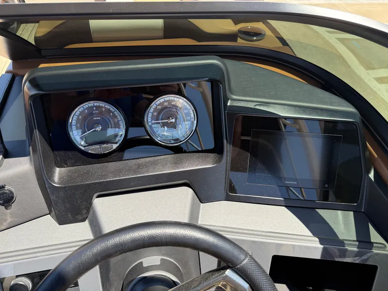 Slide: The Image of Dashboard of 2025 Avalon Catalina Quad Lounger Windshield with gauges and Garmin display. - 25