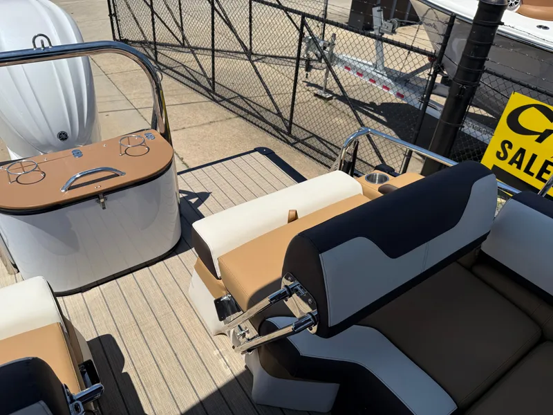 Slide: The Image of 2025 Avalon Catalina Quad Lounger Windshield boat interior with seating and control panel. - 34
