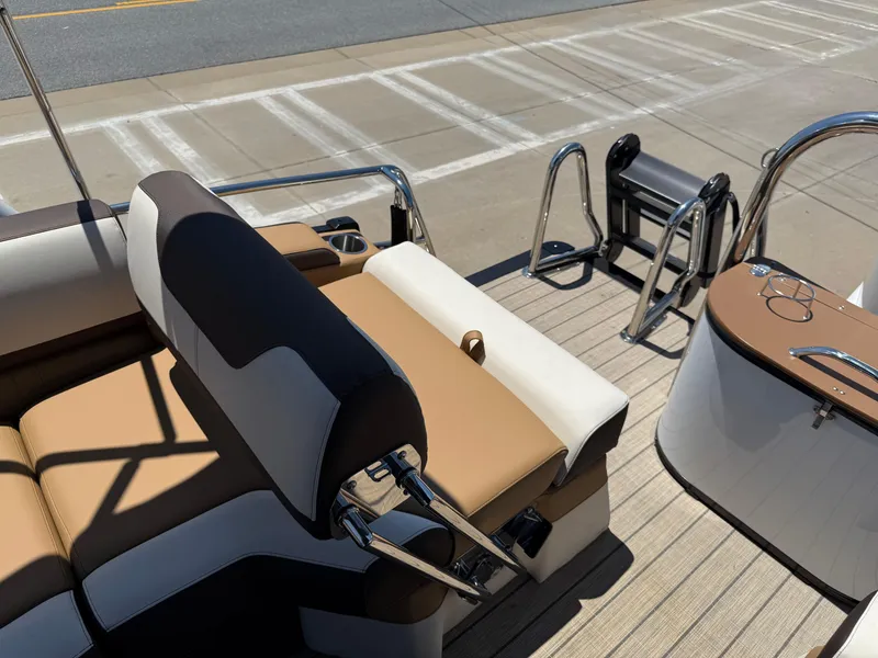 Slide: The Image of 2025 Avalon Catalina Quad Lounger Windshield with tan and white seating on a dock. - 35