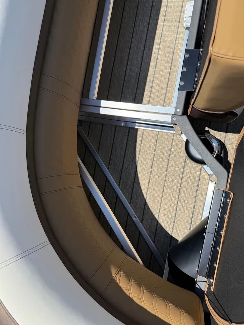 Slide: The Image of 2025 Avalon Catalina Quad Lounger Windshield interior with brown seating and metal framework. - 44