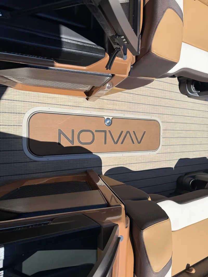 Slide: The Image of 2025 Avalon Catalina Quad Lounger Windshield interior with logo on deck flooring. - 46