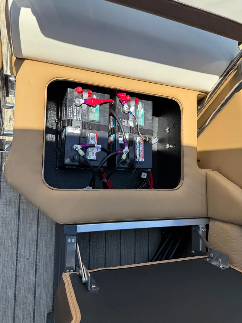 Slide: The Image of 2025 Avalon Catalina Quad Lounger Windshield battery compartment with dual batteries. - 48