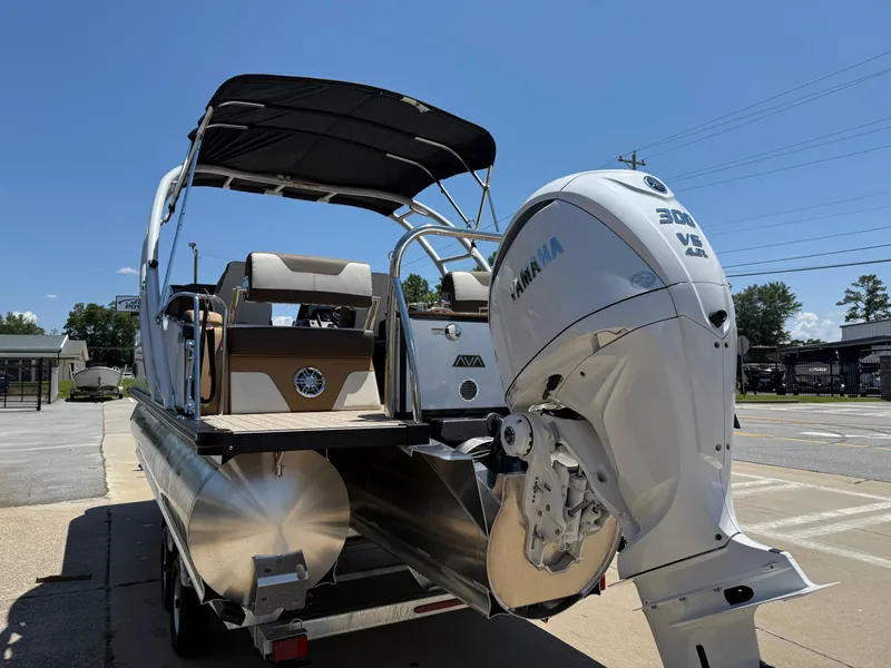 Slide: The Image of 2025 Avalon Catalina Quad Lounger Windshield boat with Yamaha 300 V6 engine, parked outdoors. - 6