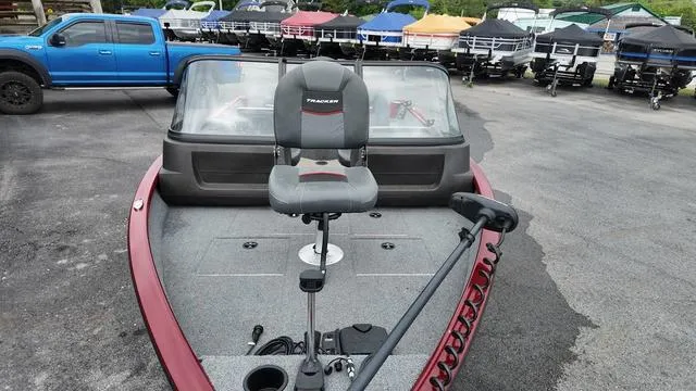 Slide: The Image of 2023 Tracker Pro Guide™ V-16 SC boat with seating and steering, parked outdoors. - 10