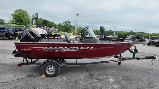 Slide: The Image of 2023 Tracker Pro Guide™ V-16 SC boat on trailer, red exterior, parked outdoors. - 6