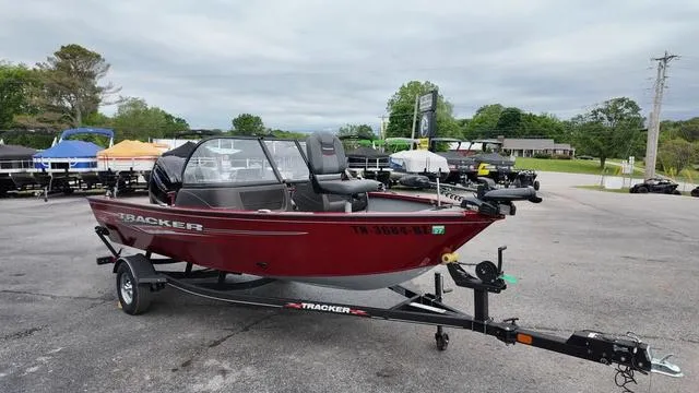 Slide: The Image of 2023 Tracker Pro Guide™ V-16 SC boat on trailer, parked outdoors, overcast sky. - 7
