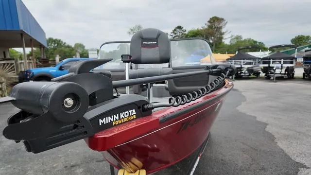 Slide: The Image of 2023 Tracker Pro Guide V-16 SC boat with Minn Kota PowerDrive motor, parked outdoors. - 9