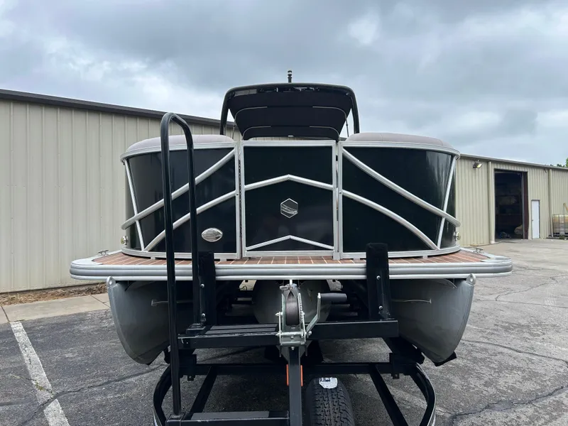 Slide: The Image of 2017 South Bay 525 RS Arch 3.0+ pontoon boat on trailer, parked outdoors. - 2
