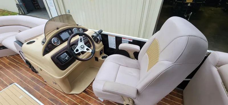 Slide: The Image of 2017 South Bay 525 RS Arch 3.0+ boat interior with steering console and plush seating. - 7