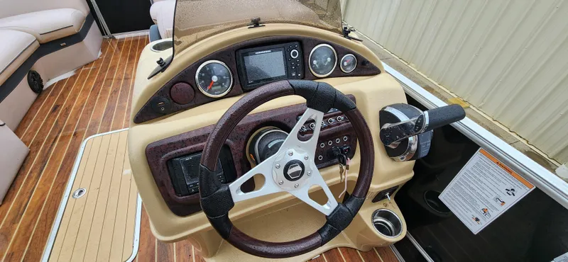 Slide: The Image of 2017 South Bay 525 RS Arch 3.0+ boat dashboard with steering wheel and controls. - 8