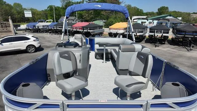 Slide: The Image of 2025 Bennington 20 SF Fish pontoon boat with seating, parked in a dealership lot. - 12