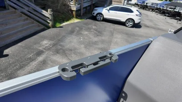 Slide: The Image of 2025 Bennington 20 SF Fish boat detail with dock and parked car in background. - 15