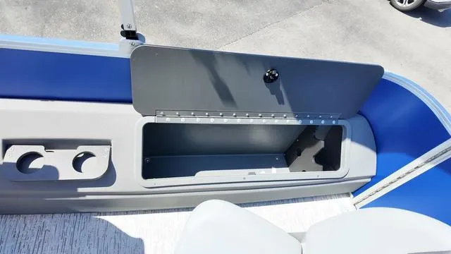 Slide: The Image of 2025 Bennington 20 SF Fish boat storage compartment with cup holders and seating area. - 21