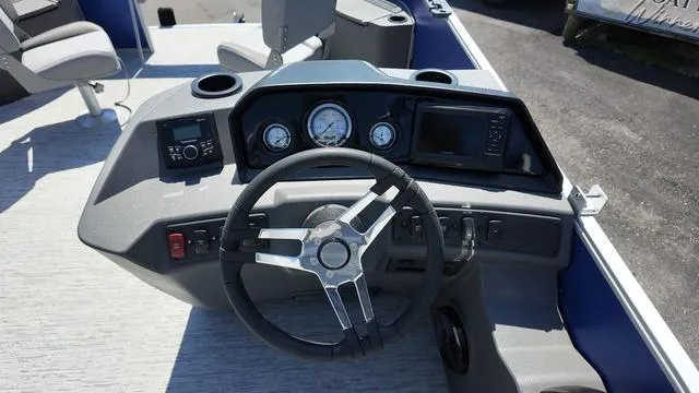 Slide: The Image of 2025 Bennington 20 SF Fish boat dashboard with steering wheel and control panel. - 23