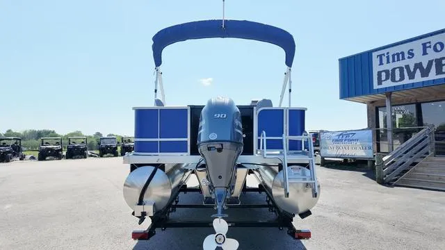 Slide: The Image of 2025 Bennington 20 SF Fish pontoon boat with blue canopy and powerful outboard motor. - 4