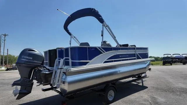 Slide: The Image of 2025 Bennington 20 SF Fish pontoon boat with Yamaha motor on trailer, under clear blue sky. - 5