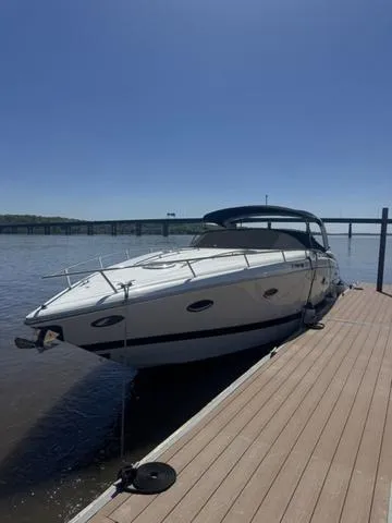 Slide: The Image of 2003 Cobalt 360 boat docked on a sunny day by a river. - 1