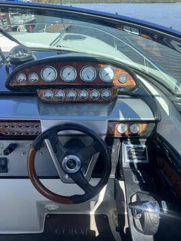 Slide: The Image of Dashboard of a 2003 Cobalt 360 boat with gauges and steering wheel. - 10