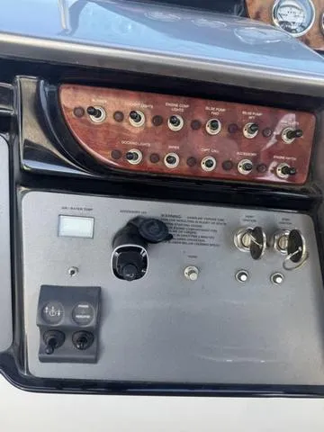 Slide: The Image of Control panel of a 2003 Cobalt 360 boat with switches and gauges. - 11