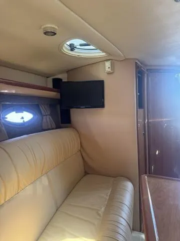 Slide: The Image of Interior of 2003 Cobalt 360 yacht with beige seating and wall-mounted TV. - 12