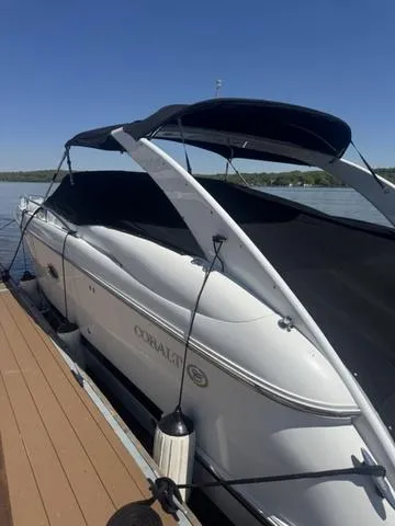 Slide: The Image of 2003 Cobalt 360 boat docked on a sunny day, featuring sleek design and black canopy. - 13
