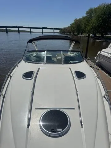 Slide: The Image of 2003 Cobalt 360 boat docked on a sunny river with a bridge in the background. - 18