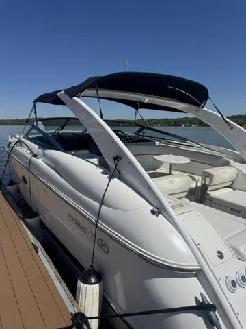 Slide: The Image of 2003 Cobalt 360 boat docked on a sunny day, featuring sleek design and spacious seating. - 2