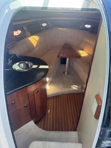 Slide: The Image of Interior of a 2003 Cobalt 360 boat with a cozy seating area and kitchenette. - 5