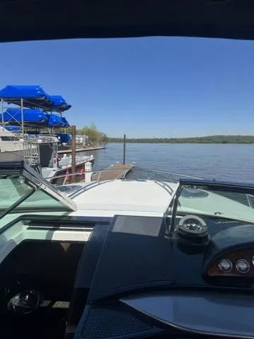 Slide: The Image of 2003 Cobalt 360 boat docked at a marina with clear blue skies. - 6