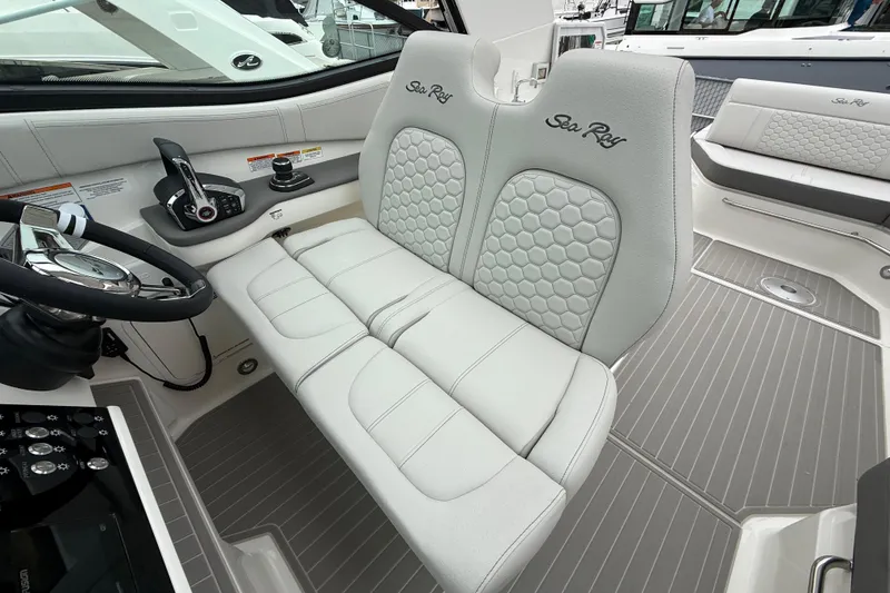 Slide: The Image of 2026 Sea Ray Sundancer 320 cockpit with luxurious seating and modern controls. - 10