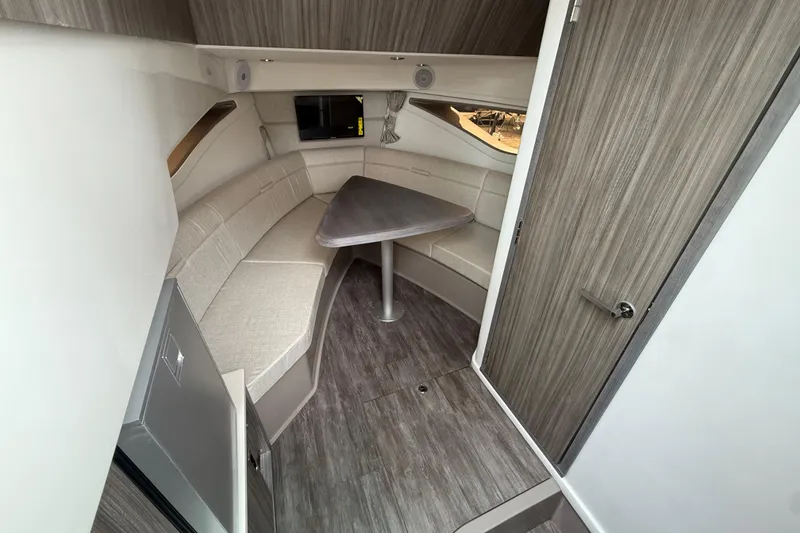 Slide: The Image of Interior of 2026 Sea Ray Sundancer 320, featuring modern seating and wood finishes. - 14