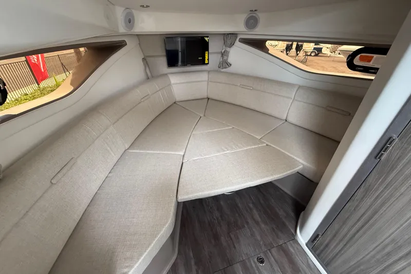 Slide: The Image of 2026 Sea Ray Sundancer 320 cabin interior with beige seating and modern design. - 17