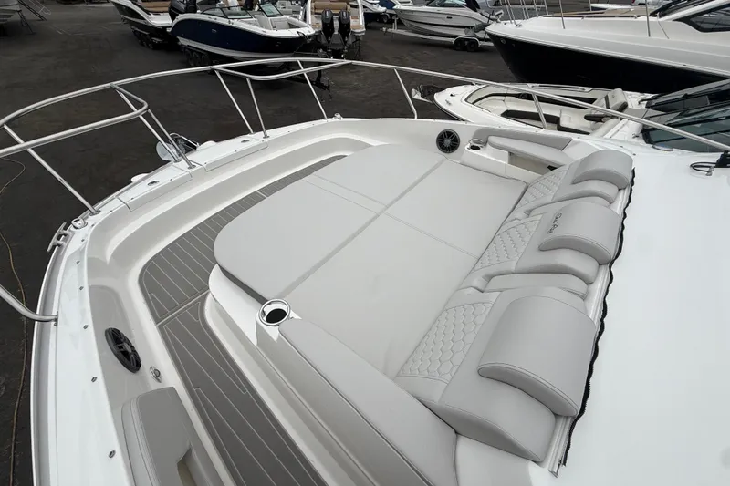 Slide: The Image of 2026 Sea Ray Sundancer 320 boat with spacious sunbathing deck and luxurious seating. - 21