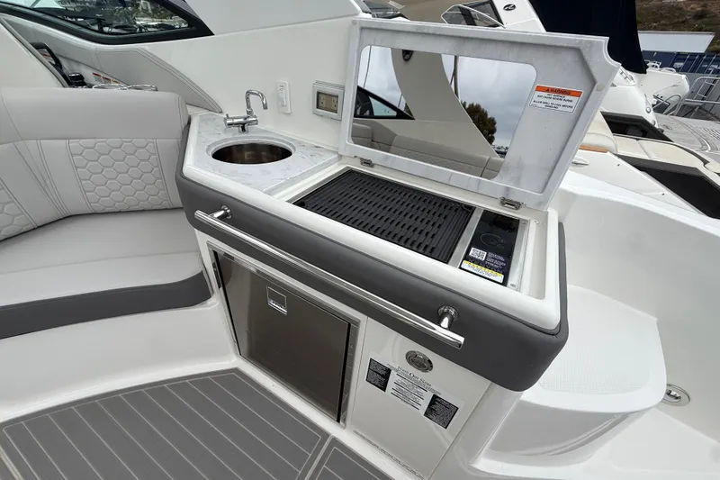 Slide: The Image of Luxurious 2026 Sea Ray Sundancer 320 yacht interior with kitchenette and seating area. - 7