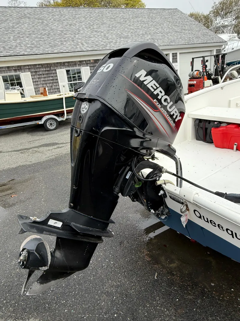 Slide: The Image of 2016 Boston Whaler 150 Super Sport with Mercury outboard motor, parked outdoors. - 10