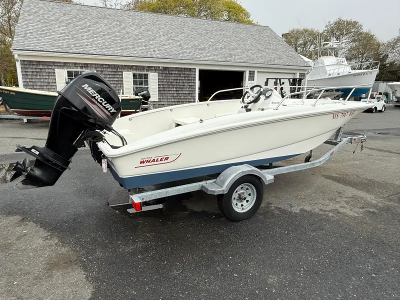 Slide: The Image of 2016 Boston Whaler 150 Super Sport boat on trailer with Mercury outboard motor. - 3