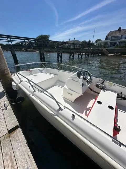 Slide: The Image of 2016 Boston Whaler 150 Super Sport docked by a wooden pier on a sunny day. - 5