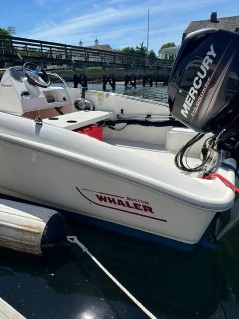 Slide: The Image of 2016 Boston Whaler 150 Super Sport boat docked with Mercury engine. - 6