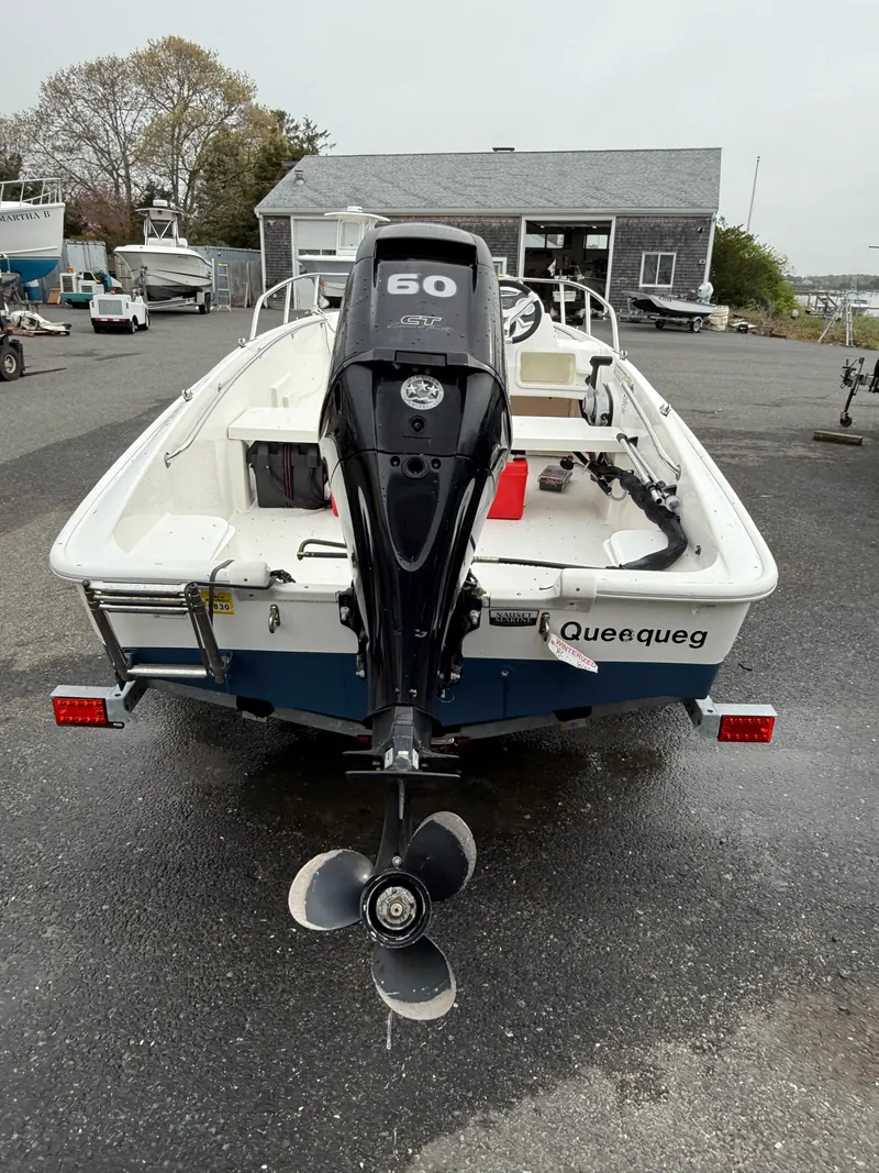 Slide: The Image of 2016 Boston Whaler 150 Super Sport boat with outboard motor, parked on a trailer. - 9