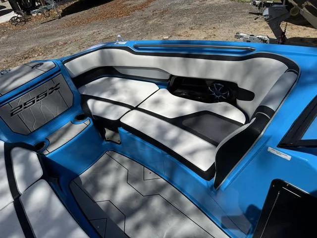 Slide: The Image of 2022 Yamaha Boats 255XD interior with blue and gray seating, showcasing modern design and comfort. - 11