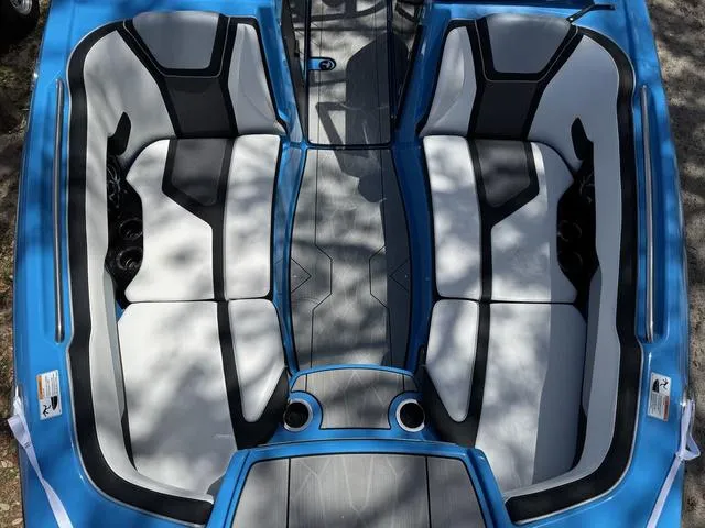 Slide: The Image of 2022 Yamaha Boats 255XD interior with blue and gray seating, top view. - 13