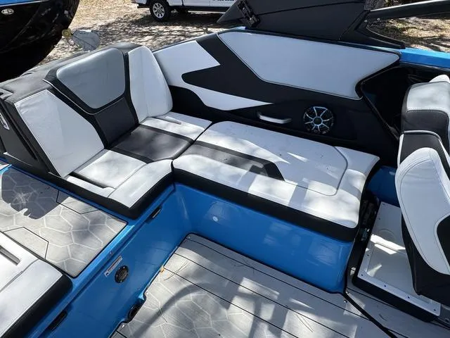 Slide: The Image of 2022 Yamaha Boats 255XD interior with sleek black and white seating and blue accents. - 17