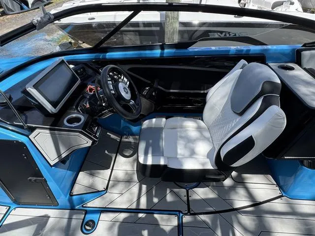 Slide: The Image of 2022 Yamaha Boats 255XD interior with modern dashboard and comfortable seating. - 20