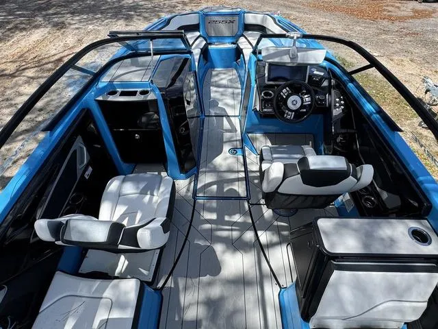 Slide: The Image of 2022 Yamaha Boats 255XD interior, featuring sleek blue and gray design with modern controls and seating. - 5