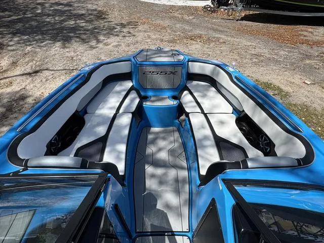 Slide: The Image of 2022 Yamaha Boats 255XD interior with blue and white seating, showcasing spacious design. - 8