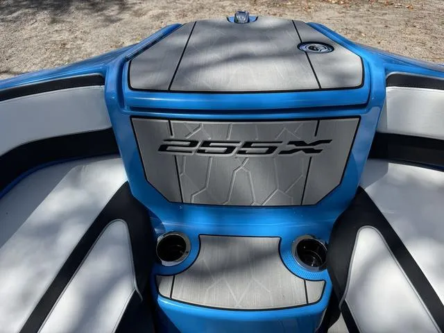 Slide: The Image of 2022 Yamaha Boats 255XD interior with blue accents and cup holders. - 9