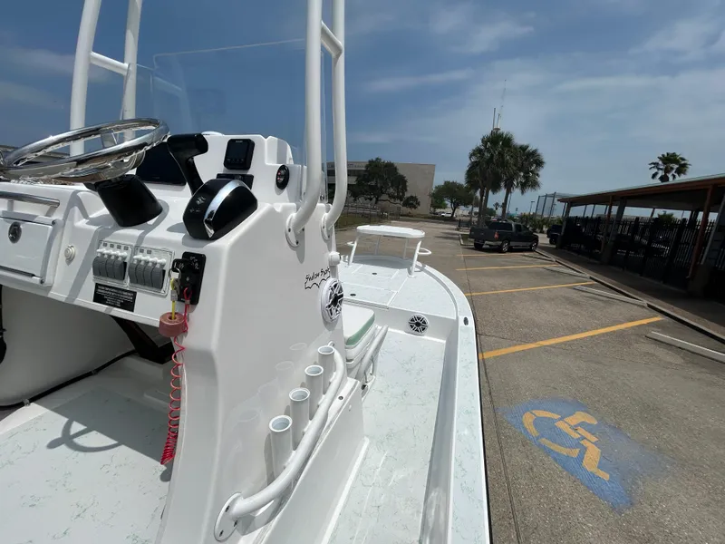 Slide: The Image of 2023 Shallow Sport 21 Sport boat parked in a lot under a clear sky. - 10