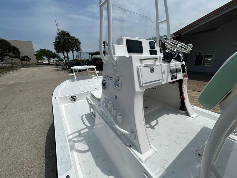 Slide: The Image of 2023 Shallow Sport 21 Sport boat with center console, docked outdoors. - 11