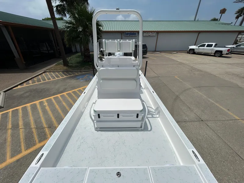 Slide: The Image of 2023 Shallow Sport 21 Sport boat with white seating, parked in a lot. - 15