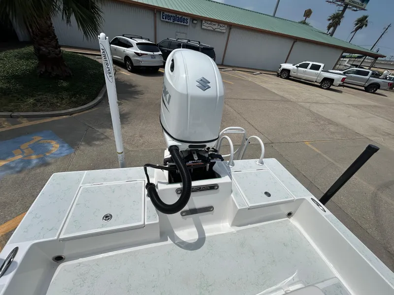 Slide: The Image of 2023 Shallow Sport 21 Sport boat with Suzuki outboard motor in a parking lot. - 7